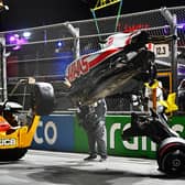 Track marshals clean debris from the track following the crash of Mick Schumacher during qualifying ahead of the F1 Grand Prix of Saudi Arabia at the Jeddah Corniche Circuit. (Photo by Clive Mason/Getty Images)