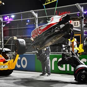 Track marshals clean debris from the track following the crash of Mick Schumacher during qualifying ahead of the F1 Grand Prix of Saudi Arabia at the Jeddah Corniche Circuit. (Photo by Clive Mason/Getty Images)