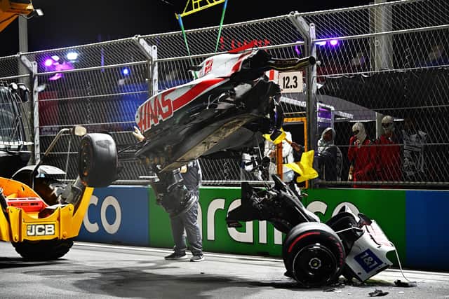 Track marshals clean debris from the track following the crash of Mick Schumacher during qualifying ahead of the F1 Grand Prix of Saudi Arabia at the Jeddah Corniche Circuit. (Photo by Clive Mason/Getty Images)