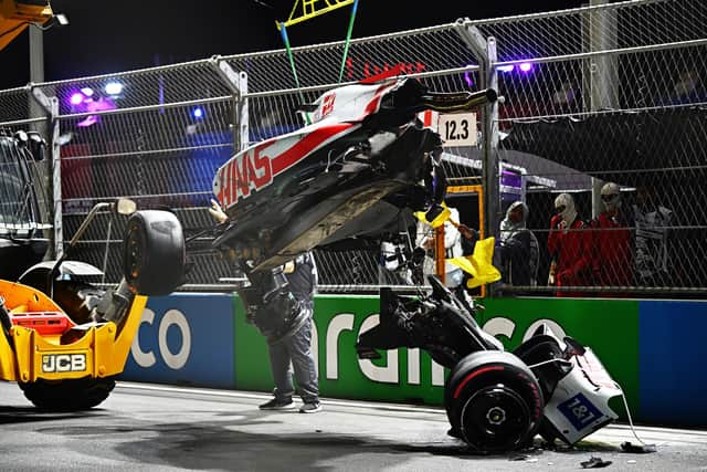 Track marshals clean debris from the track following the crash of Mick Schumacher during qualifying ahead of the F1 Grand Prix of Saudi Arabia at the Jeddah Corniche Circuit. (Photo by Clive Mason/Getty Images)