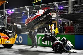 Track marshals clean debris from the track following the crash of Mick Schumacher during qualifying ahead of the F1 Grand Prix of Saudi Arabia at the Jeddah Corniche Circuit. (Photo by Clive Mason/Getty Images)
