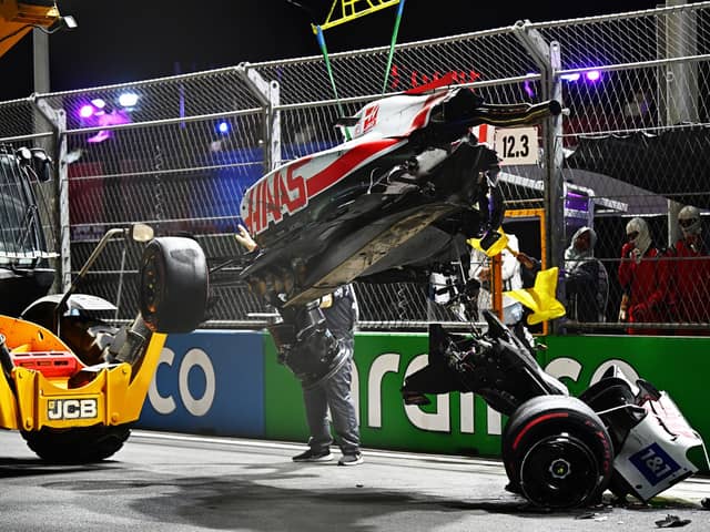 Track marshals clean debris from the track following the crash of Mick Schumacher during qualifying ahead of the F1 Grand Prix of Saudi Arabia at the Jeddah Corniche Circuit. (Photo by Clive Mason/Getty Images)