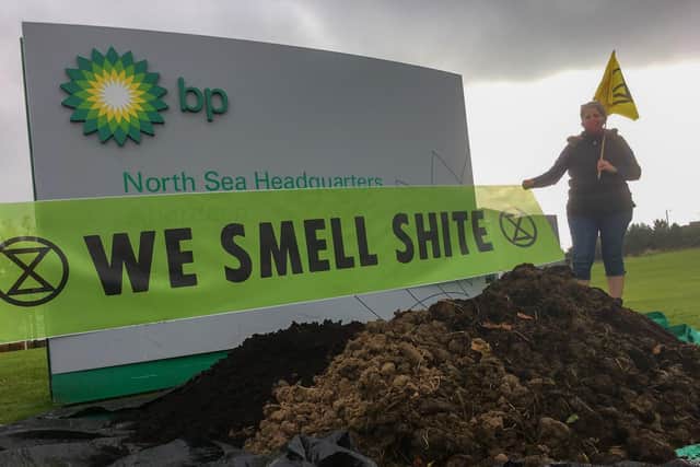 The non-violent climate change activist group dump manure outside BP offices.