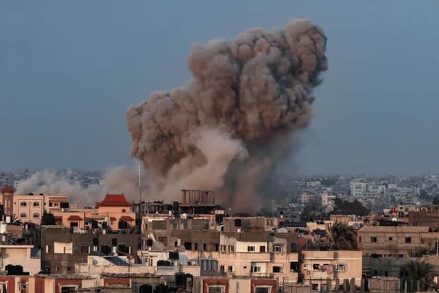Smoke plumes rising above buildings during an Israeli strike on Rafah in the southern Gaza Strip on October 14, 2023. Hamas launched a large-scale attack on Israel on October 7 which killed at least 1300 people, sparking a retaliatory bombing campaign that has killed more than 1900 in the Gaza Strip ahead of a potential Israeli ground invasion of the territory. (Photo by SAID KHATIB / AFP) (Photo by SAID KHATIB/AFP via Getty Images)