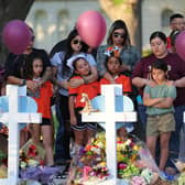 UVALDE, TEXAS - MAY 26: People visit memorials for victims of Tuesday's mass shooting at a Texas elementary school, in City of Uvalde Town Square on May 26, 2022 in Uvalde, Texas. (Photo by Michael M. Santiago/Getty Images)