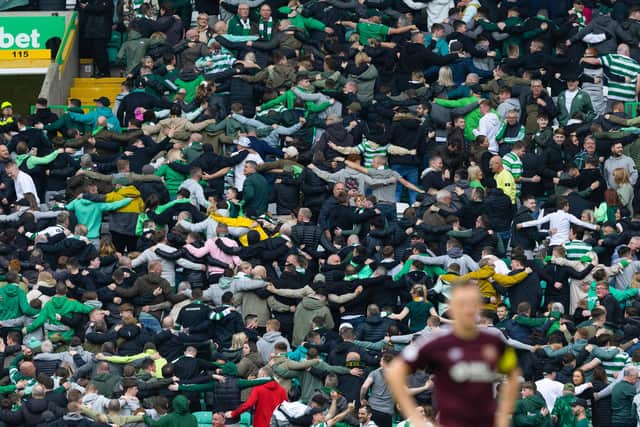 Celtic fans do the huddle celebration in the stands during the 3-0 win over Hearts. (Photo by Craig Williamson / SNS Group)