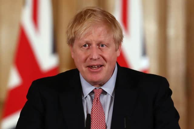 Prime Minister Boris Johnson holds a news conference addressing the government's response to the coronavirus outbreak on March 12, 2020 in London, England. (Photo by Simon Dawson-WPA Pool/Getty Images)