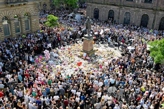 Members of the public observe a minute's silence in central Manchester in memory of the 22 people who were murdered in the Manchester Arena terrorist attack in May 2017 (Picture: Jeff J Mitchell/Getty Images)