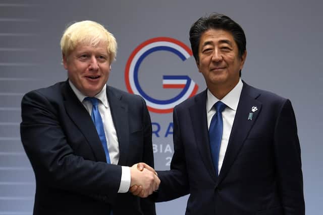 Prime Minister Boris Johnson meeting the then Japanese Prime Minister Shinzo Abe for bilateral talks during the G7 summit in Biarritz, France. Japan's former prime minister Shinzo Abe has died after being shot during a campaign speech in western Japan. Issue date: Friday July 8, 2022.