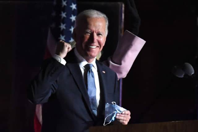 Joe Biden gestures as he arrives onstage to address supporters during election night  (Photo by Roberto SCHMIDT / AFP) (Photo by ROBERTO SCHMIDT/AFP via Getty Images)