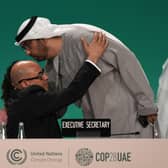 United Nations Climate Chief Simon Stiell embraces COP28 President Sultan al-Jaber as he returns to a plenary session at the summit. Picture: AP Photo/Kamran Jebreili