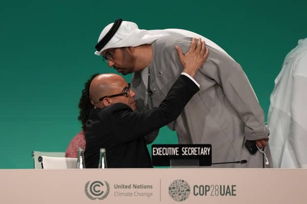 United Nations Climate Chief Simon Stiell embraces COP28 President Sultan al-Jaber as he returns to a plenary session at the summit. Picture: AP Photo/Kamran Jebreili