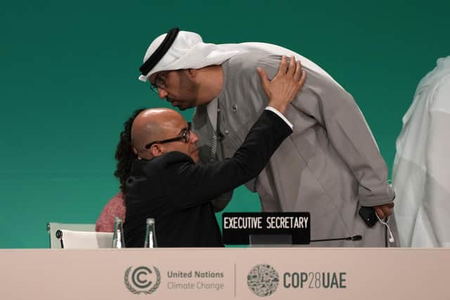 United Nations Climate Chief Simon Stiell embraces COP28 President Sultan al-Jaber as he returns to a plenary session at the summit. Picture: AP Photo/Kamran Jebreili