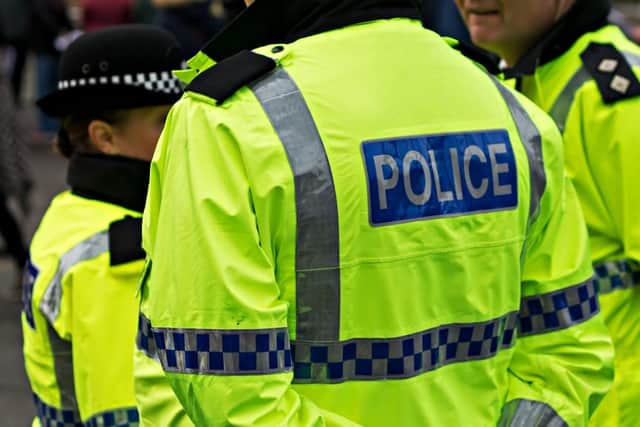 Three people have been charged after a teenager and a man were allegedly attacked in separate incidents in the same street.