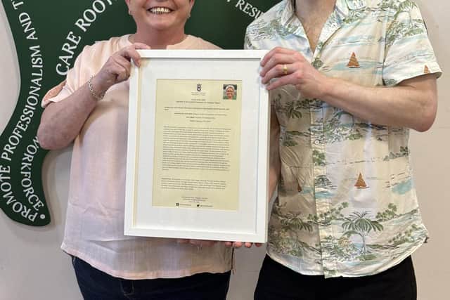 Annie Wells MSP presenting David Addison with the motion at Oakview Manor