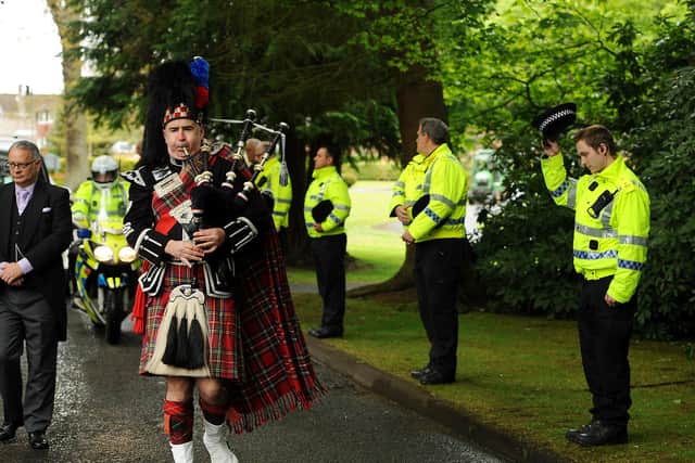 Funeral of Sandy Marr. A piper leading the funeral procession. Pic: Fife Photo Agency.