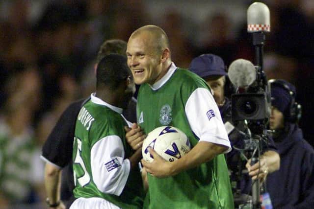 Mixu Paatelainen clutches the match ball after scoring a hat-trick for Hibs in a 6-2 win over Hearts on October 22, 2000.