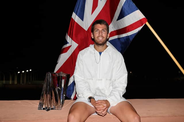 Cameron Norrie poses for an off court photograph with his winners trophy after his three set victory against Nikoloz Basilashvili of Georgia in the men's final match on Day 14 of the BNP Paribas Open at the Indian Wells Tennis Garden.