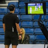 Referee reviews the VAR monitor for a potential penalty during Rangers and Red Star Belgrade. (Photo by Craig Foy / SNS Group)