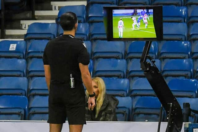 Referee reviews the VAR monitor for a potential penalty during Rangers and Red Star Belgrade. (Photo by Craig Foy / SNS Group)