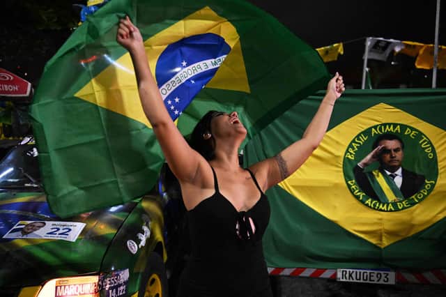 A supporter of Brazilian President and re-election candidate Jair Bolsonaro reacts as she watches the vote count of the legislative and presidential election, in Rio de Janeiro, Brazil, on October 2, 2022.Photo by CARL DE SOUZA via Getty Images