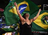 A supporter of Brazilian President and re-election candidate Jair Bolsonaro reacts as she watches the vote count of the legislative and presidential election, in Rio de Janeiro, Brazil, on October 2, 2022.Photo by CARL DE SOUZA via Getty Images