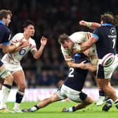 Alex Dombrandt of England is tackled by Scotland duo George Turner and Pierre Schoeman.