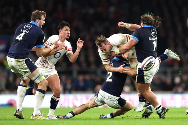 Alex Dombrandt of England is tackled by Scotland duo George Turner and Pierre Schoeman.