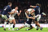 Alex Dombrandt of England is tackled by Scotland duo George Turner and Pierre Schoeman.