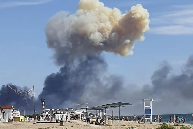 Rising smoke can be seen from the beach at Saky after explosions were heard from the direction of a Russian military airbase near Novofedorivka, Crimea. Picture: UGC via AP