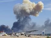Rising smoke can be seen from the beach at Saky after explosions were heard from the direction of a Russian military airbase near Novofedorivka, Crimea. Picture: UGC via AP