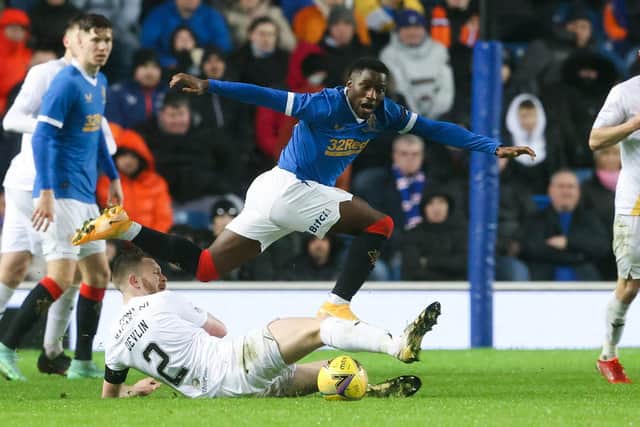 Rangers' Fashion Sakala is tackled by Livingston's Nicky Devlin during the match at Ibrox on Wednesday. (Photo by Alan Harvey / SNS Group)