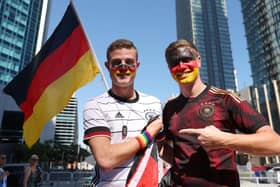 Germany fans pose for a photo wearing a rainbow wristband in Doha, Qatar.