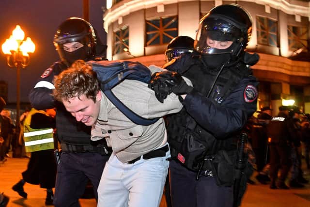 Police officers detain a man in Moscow following calls to protest against partial mobilisation announced by President Vladimir Putin. Picture: Alexander Nemenov/AFP via Getty Images