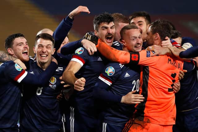 Just before the boogie-ing began, Andy (far left) and the Scotland players celebrate Euros qualification on the pitch