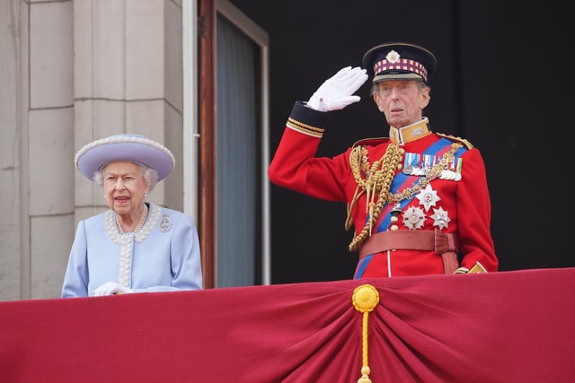 Queen Elizabeth II and the Duke of Kent watch from the balcony.