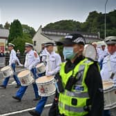 An orange parade passes St Benedict's catholic church in Easterhouse where a counter protest by Call It Out gathered on September 18, 2021 in Glasgow, Scotland. Around 13,000 marchers are expected to take part in more than 50 parades through the city centre heading to Glasgow Green to celebrate the 200th anniversary of the first Battle of the Boyne parade in Glasgow. (Photo by Jeff J Mitchell/Getty Images)