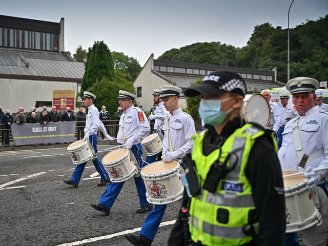An orange parade passes St Benedict's catholic church in Easterhouse where a counter protest by Call It Out gathered on September 18, 2021 in Glasgow, Scotland. Around 13,000 marchers are expected to take part in more than 50 parades through the city centre heading to Glasgow Green to celebrate the 200th anniversary of the first Battle of the Boyne parade in Glasgow. (Photo by Jeff J Mitchell/Getty Images)