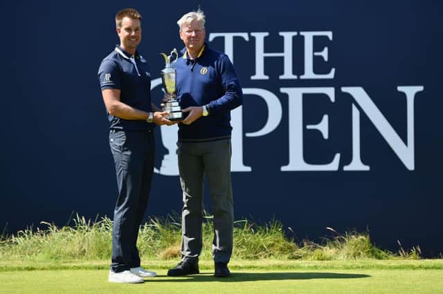 Henrik Stenson returns the Claret Jug to R&A chief executive Martin Slumbers at the end of a 12-month reign as champion following his victory at Royal Troon in 2016. Picture: Dan Mullan/Getty Images