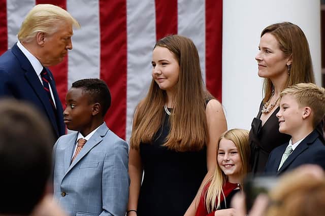 Donald Trump walks by Judge Amy Coney Barrett (right) in the Rose Garden of the White House (Picture: Olivier Douliery/AFP via Getty Images)
