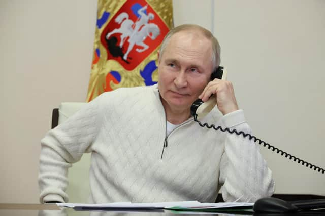 Russian president Vladimir Putin speaks on the phone. Picture: Mikhail Klimentyev, Sputnik, Kremlin Pool Photo via AP