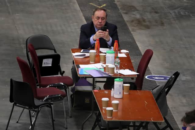 ALBA party leader Alex Salmond on his phone as votes are being counted in Aberdeen.