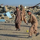 Boys play cricket in front of a school that was damaged during the conflict between the Taliban and Afghanistan's former ruling government, in Kandahar in May. Incidents in Afghanistan account for 30 per cent of all verified occasions of violations against children in conflict situations. Picture: AFP via Getty Images