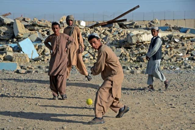 Boys play cricket in front of a school that was damaged during the conflict between the Taliban and Afghanistan's former ruling government, in Kandahar in May. Incidents in Afghanistan account for 30 per cent of all verified occasions of violations against children in conflict situations. Picture: AFP via Getty Images