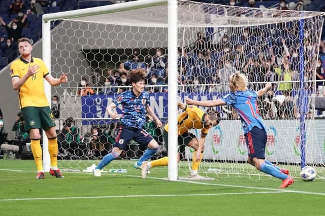 Kyogo Furuhashi, centre, looks on as Aziz Behich inadvertently scores a winning goal for Japan as Australia lose in Saitama. Picture: Getty