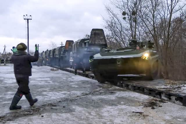 A Russian armoured vehicle drives off a railway platform after arrival in Belarus. Picture: Russian Defense Ministry Press Service via AP