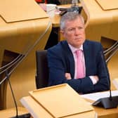 Leader of the Scottish Liberal Democrat Party Willie Rennie looks on while First Minister Nicola Sturgeon speaks in the Scottish Parliament.