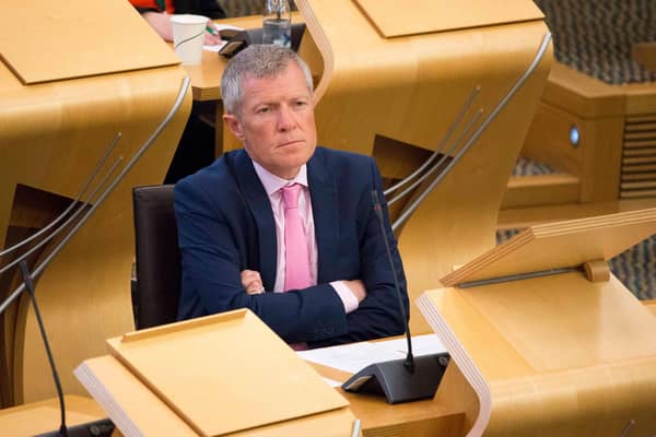 Leader of the Scottish Liberal Democrat Party Willie Rennie looks on while First Minister Nicola Sturgeon speaks in the Scottish Parliament.