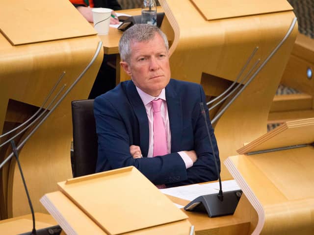 Leader of the Scottish Liberal Democrat Party Willie Rennie looks on while First Minister Nicola Sturgeon speaks in the Scottish Parliament.