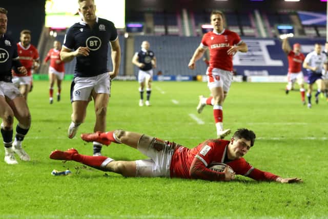 Wales' Louis Rees-Zammit dives in to score his side's fourth try.